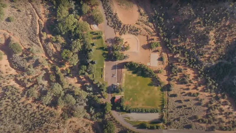 Engineers examining creek and surrounding landscape